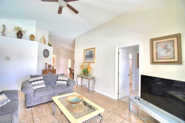 tiled living room featuring a textured ceiling, ceiling fan, and lofted ceiling