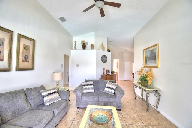 tiled living room featuring ceiling fan, high vaulted ceiling, and a textured ceiling