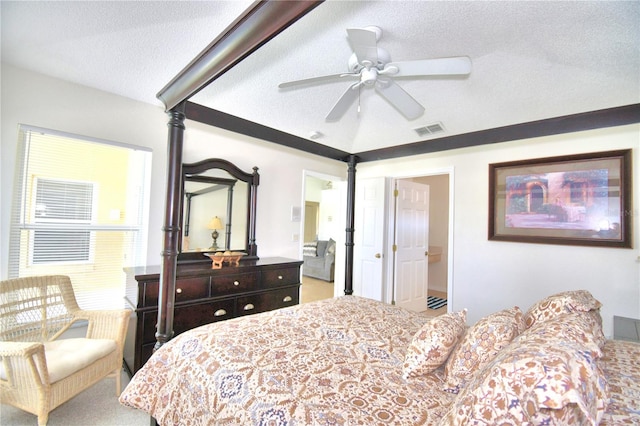 bedroom with carpet flooring, connected bathroom, ceiling fan, and a textured ceiling