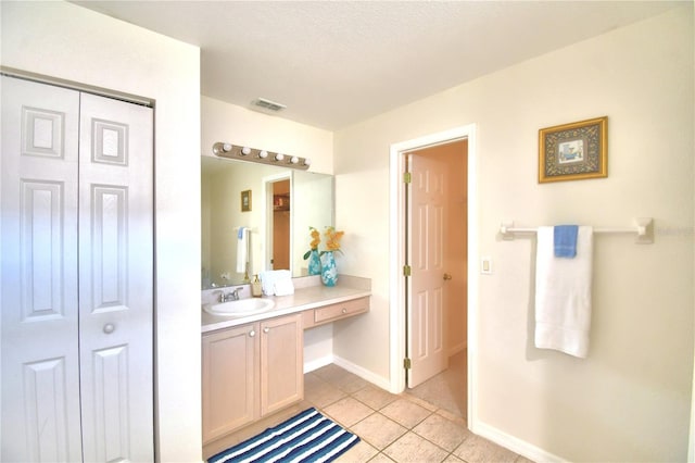 bathroom with vanity and tile patterned floors