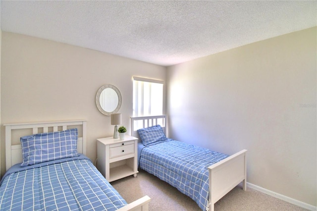 bedroom featuring a textured ceiling and light carpet