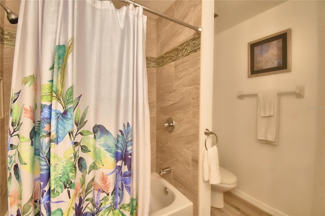 bathroom featuring shower / bath combination with curtain, hardwood / wood-style flooring, and toilet