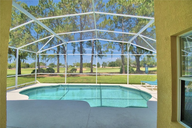 view of swimming pool featuring a patio area, a lanai, and a yard