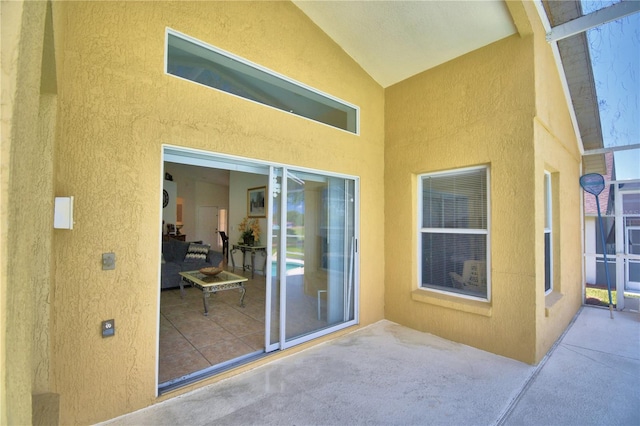 entrance to property featuring a patio