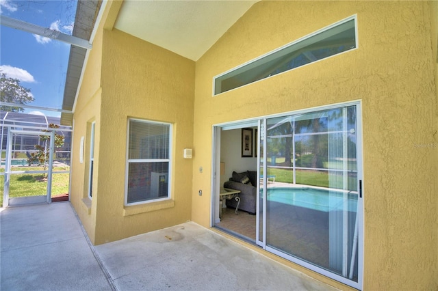 view of patio / terrace featuring glass enclosure