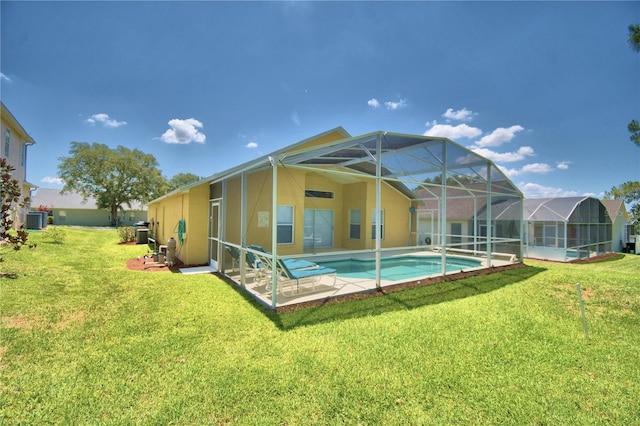 back of house featuring a patio, a yard, glass enclosure, and cooling unit