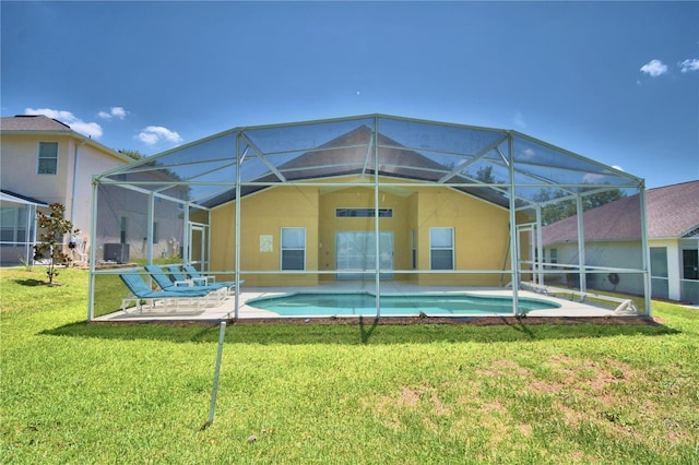 back of house featuring a lanai, a lawn, and a patio