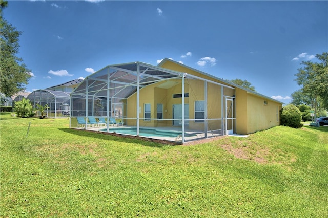 back of property featuring a lanai and a lawn