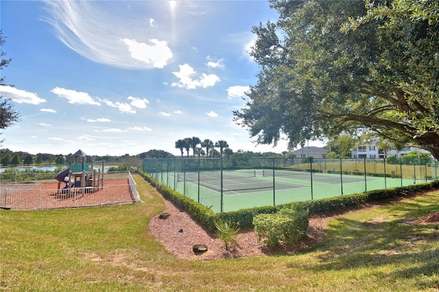 view of sport court with a playground and a yard