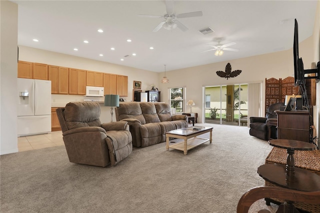 carpeted living room with ceiling fan