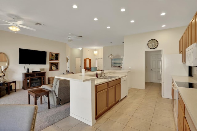 kitchen featuring a kitchen island with sink, sink, light tile patterned flooring, and white appliances