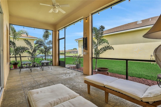 sunroom / solarium featuring ceiling fan