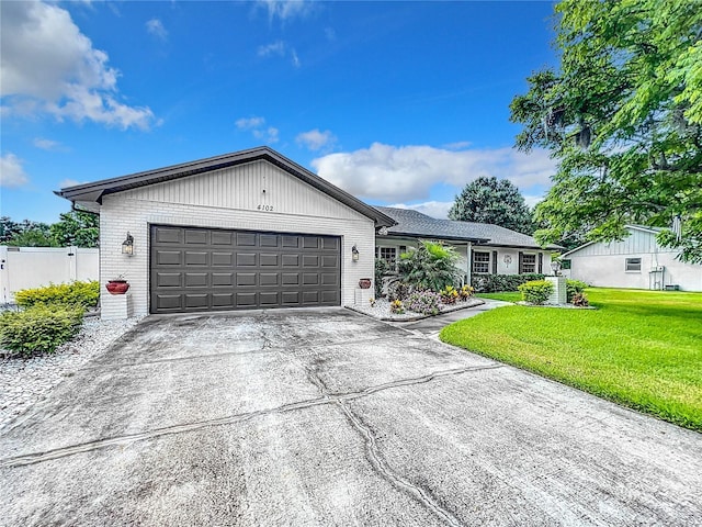 ranch-style home with a front yard and a garage