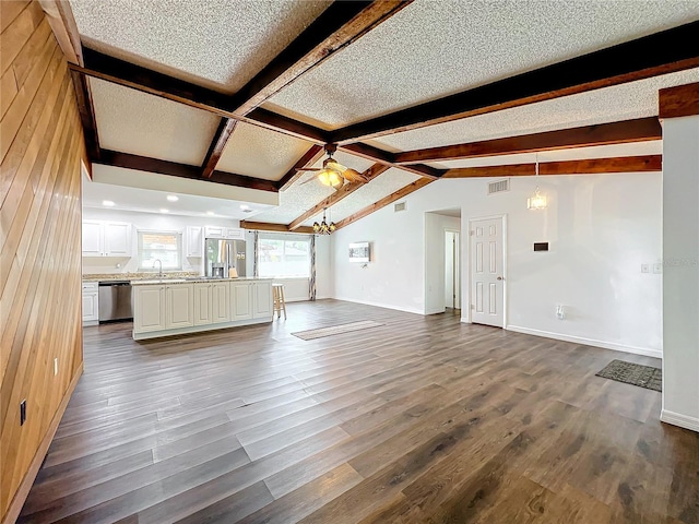 unfurnished living room featuring ceiling fan, sink, dark wood-type flooring, and a textured ceiling