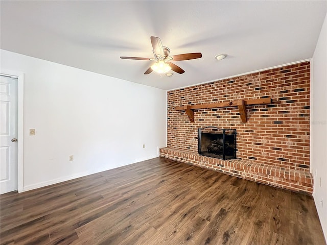 unfurnished living room featuring ceiling fan, a fireplace, and dark hardwood / wood-style floors