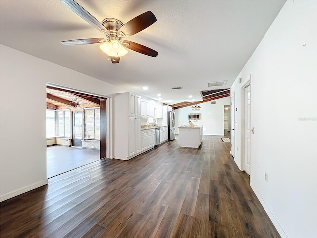 unfurnished living room with ceiling fan, dark hardwood / wood-style flooring, and a textured ceiling