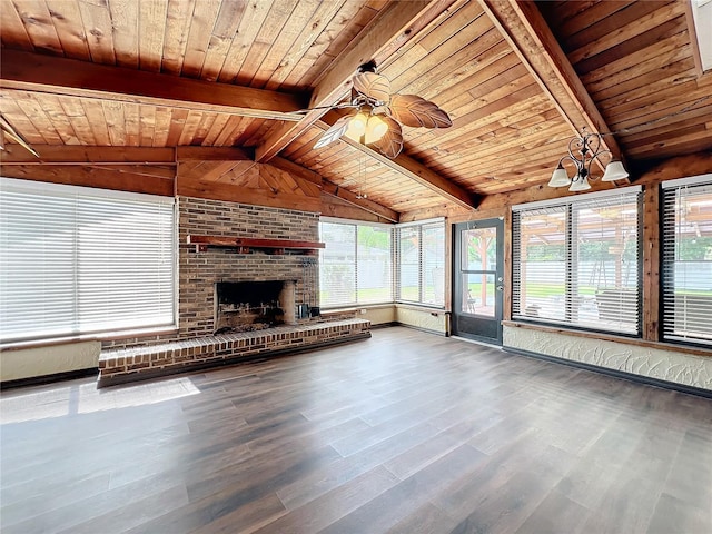 unfurnished living room with ceiling fan with notable chandelier, wooden ceiling, a fireplace, hardwood / wood-style floors, and vaulted ceiling with beams