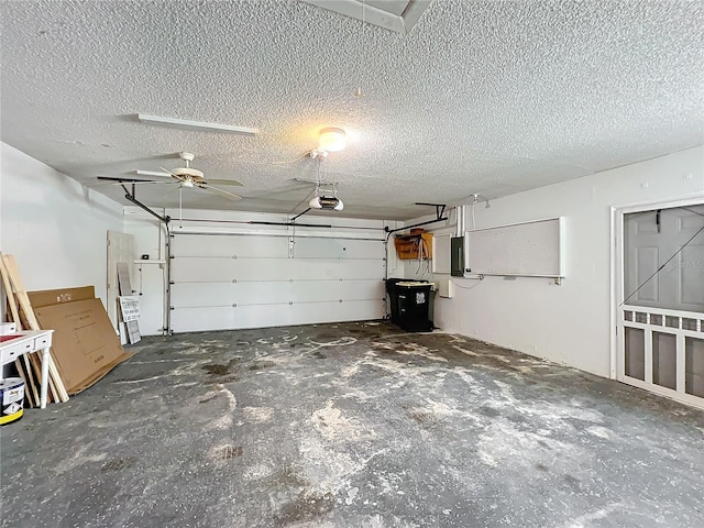 garage featuring electric panel, ceiling fan, and a garage door opener