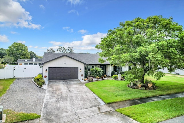 view of front of home with a garage and a front lawn