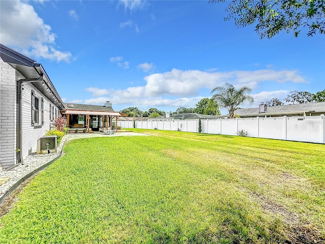 view of yard with a patio and central AC unit