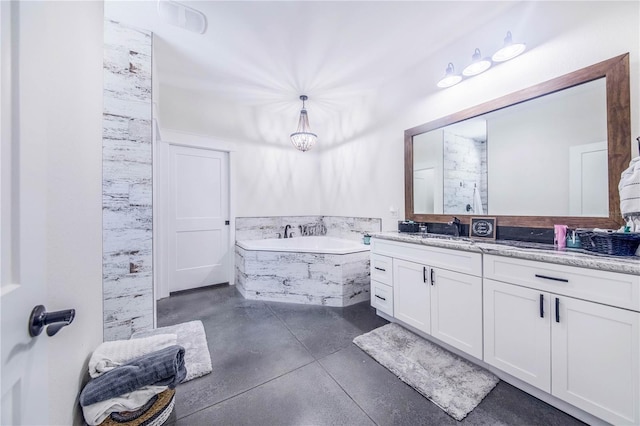 bathroom featuring vanity and a relaxing tiled tub