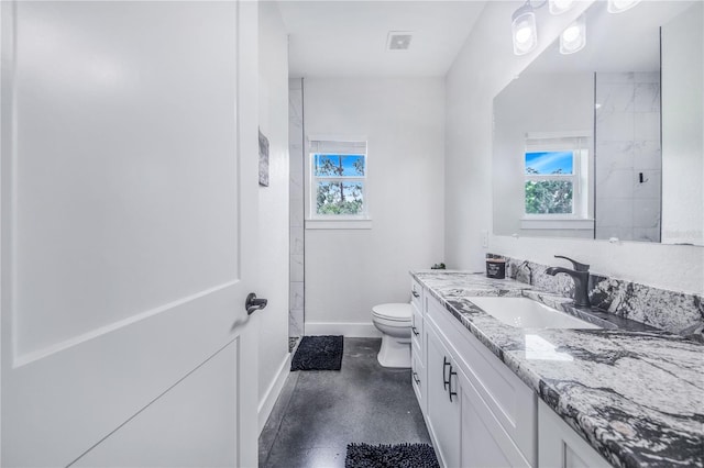 bathroom featuring vanity and toilet