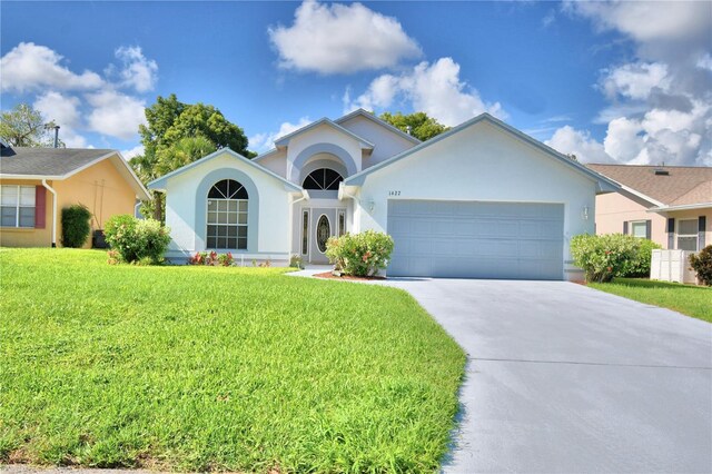 ranch-style house with a front yard and a garage