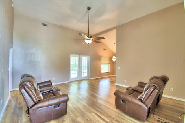 living room with light wood-type flooring, baseboards, visible vents, and french doors