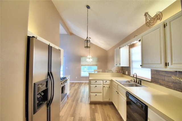 kitchen with decorative light fixtures, vaulted ceiling with beams, stainless steel appliances, light countertops, and a sink