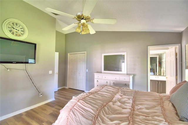 bedroom featuring baseboards, a ceiling fan, wood finished floors, vaulted ceiling, and a closet