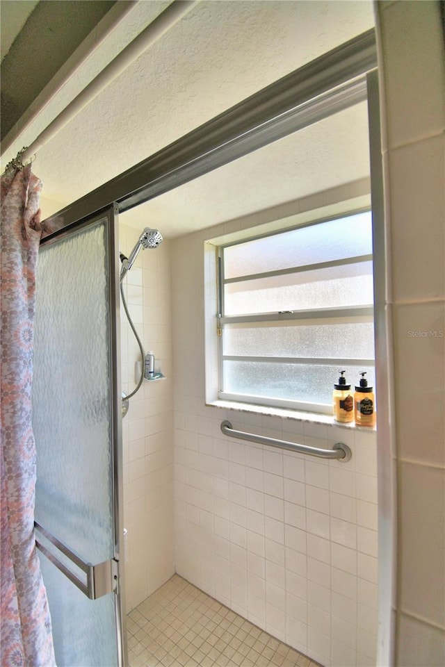 bathroom featuring a stall shower and tile patterned floors