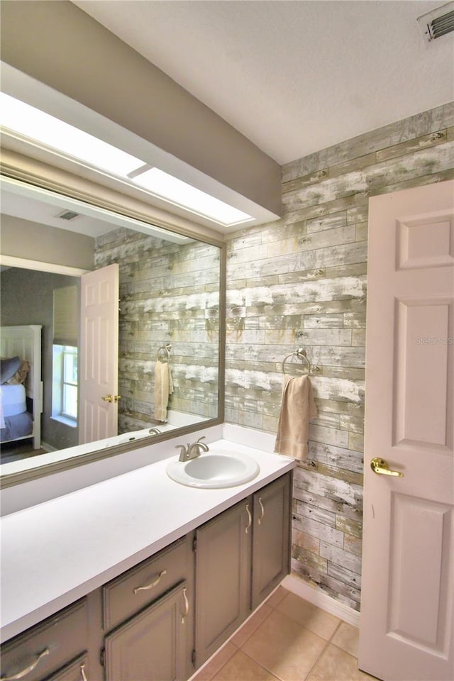 bathroom featuring visible vents, vanity, and tile patterned floors