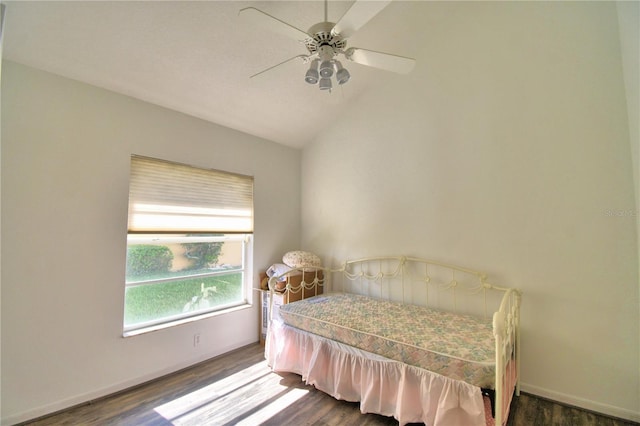 bedroom featuring lofted ceiling, dark wood-style flooring, and baseboards