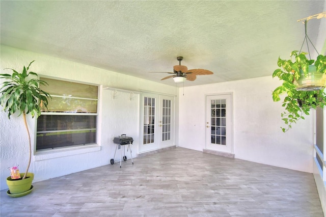 view of patio featuring ceiling fan and french doors