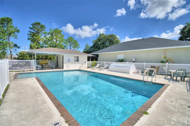 community pool featuring a patio and fence