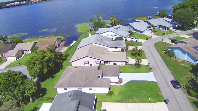 drone / aerial view with a water view and a residential view