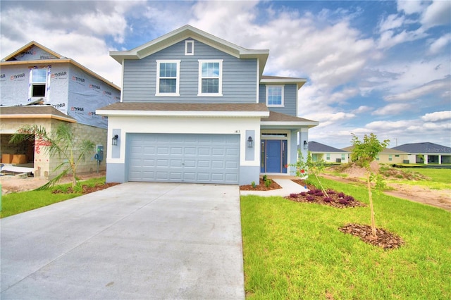 view of front of house featuring a front lawn and a garage