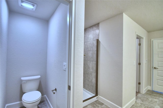 bathroom with toilet and an enclosed shower