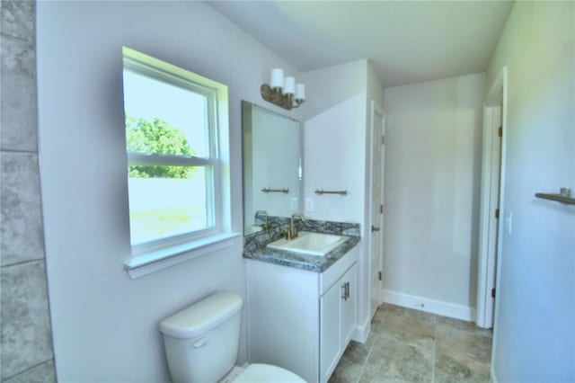 bathroom featuring vanity, toilet, and a wealth of natural light