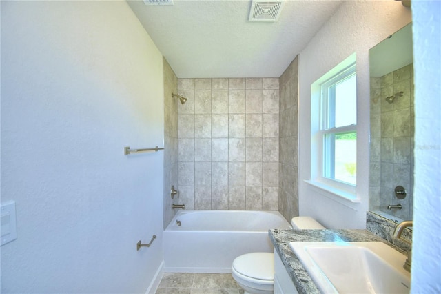 full bathroom with tile patterned floors, a wealth of natural light, vanity, and toilet