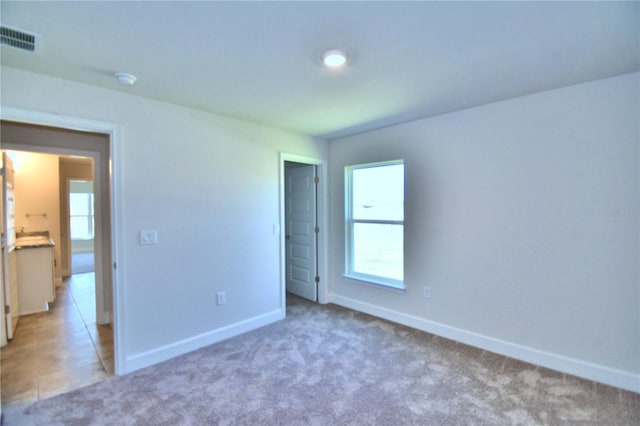 unfurnished bedroom with carpet flooring