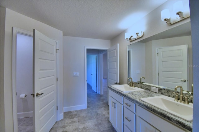 bathroom with vanity and a textured ceiling