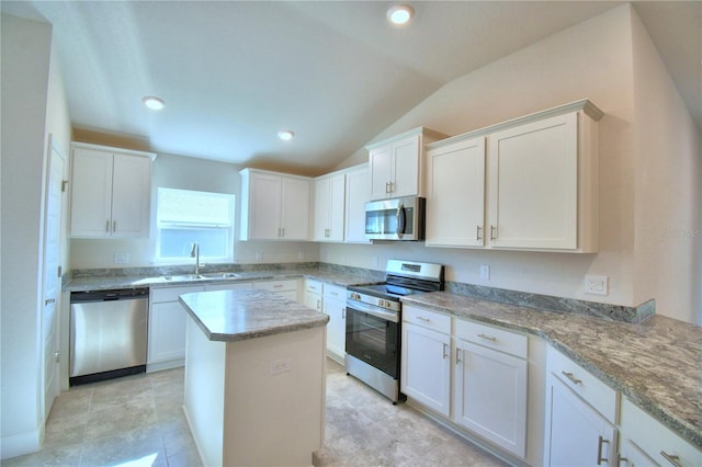 kitchen featuring white cabinetry, stainless steel appliances, and vaulted ceiling