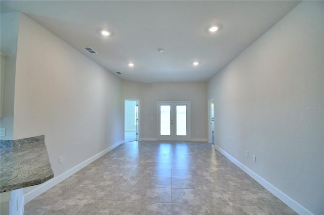 unfurnished room featuring french doors