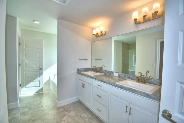 bathroom featuring a tub to relax in, tile patterned flooring, and vanity