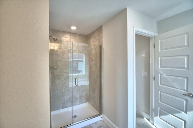 bathroom featuring a shower with door