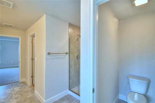 bathroom with walk in shower, tile patterned floors, and toilet