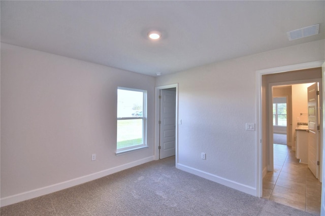 empty room featuring light carpet