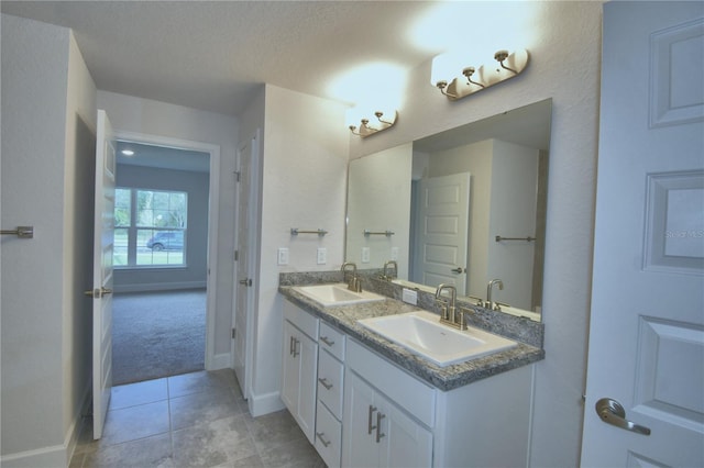 bathroom with vanity, a textured ceiling, and tile patterned floors