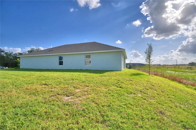 rear view of house with a yard